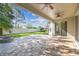 Paver patio with fire pit overlooking a fenced yard at 9317 Bella Vita Cir, Land O Lakes, FL 34637