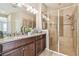 Stylish bathroom features a glass enclosed shower with seating, and granite-topped double vanity at 9317 Bella Vita Cir, Land O Lakes, FL 34637
