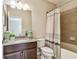 Bathroom featuring granite counters, wood cabinets and shower and tub combo at 9317 Bella Vita Cir, Land O Lakes, FL 34637