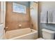 Bathroom featuring a bathtub with tile surround and a window for natural light at 9317 Bella Vita Cir, Land O Lakes, FL 34637