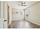 Bright, airy bedroom with wood-look flooring, a ceiling fan, and ample sunlight at 9317 Bella Vita Cir, Land O Lakes, FL 34637