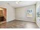 Bedroom with vinyl floors, neutral paint and view of attached bath at 9317 Bella Vita Cir, Land O Lakes, FL 34637