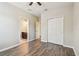 Bedroom with wood-look flooring and a closet, leading to an ensuite bathroom at 9317 Bella Vita Cir, Land O Lakes, FL 34637