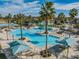 Extensive community pool featuring a splash pad, lounging areas, and lush landscaping, perfect for Gathering fun at 9317 Bella Vita Cir, Land O Lakes, FL 34637