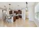 Open-concept kitchen with a center island, tile floors, pendant lights, and dark wood cabinetry at 9317 Bella Vita Cir, Land O Lakes, FL 34637
