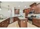 This kitchen features granite countertops, stainless appliances, wood cabinets, and a center island at 9317 Bella Vita Cir, Land O Lakes, FL 34637