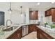 A kitchen with granite countertops, stainless steel appliances and dark wood cabinets at 9317 Bella Vita Cir, Land O Lakes, FL 34637