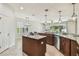 Bright kitchen with granite countertops, center island, stainless appliances and view to the living room at 9317 Bella Vita Cir, Land O Lakes, FL 34637