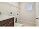 Practical laundry room with countertop, storage shelf, and window, offering convenience at 9317 Bella Vita Cir, Land O Lakes, FL 34637