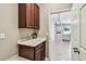 Laundry room featuring a utility sink, upper cabinets and access to the living area at 9317 Bella Vita Cir, Land O Lakes, FL 34637