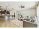 Spacious living room with tile flooring, ceiling fan, and an open concept to the kitchen at 9317 Bella Vita Cir, Land O Lakes, FL 34637