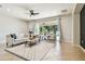 Bright living room features a ceiling fan, large windows and comfortable seating at 9317 Bella Vita Cir, Land O Lakes, FL 34637
