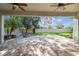 Covered patio with brick pavers, fire pit, and a view of the backyard at 9317 Bella Vita Cir, Land O Lakes, FL 34637