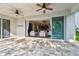 Covered patio with ceiling fans open to kitchen and living spaces at 9317 Bella Vita Cir, Land O Lakes, FL 34637