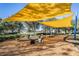Playground featuring seesaws, swings, and shade awnings over a mulch play surface at 9317 Bella Vita Cir, Land O Lakes, FL 34637