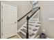 Staircase with wood steps, white risers, and a dark wood handrail leading to the upper level at 9317 Bella Vita Cir, Land O Lakes, FL 34637