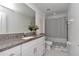 Bright bathroom features granite countertops, modern fixtures, shower and ample vanity storage at 9734 Branching Ship Trce, Wesley Chapel, FL 33545