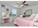 Bright bedroom with vanity station, large window and comfortable bedding at 9734 Branching Ship Trce, Wesley Chapel, FL 33545