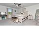 Inviting bedroom features a plush bed, soft carpet, ceiling fan and natural light from the window at 9734 Branching Ship Trce, Wesley Chapel, FL 33545