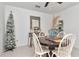 Bright dining area features a wooden table, white chairs, decorative accents, and tiled flooring at 9734 Branching Ship Trce, Wesley Chapel, FL 33545