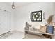 Cozy entryway featuring a decorative bench, ornamental wall art, and neutral colors at 9734 Branching Ship Trce, Wesley Chapel, FL 33545