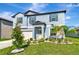 Charming home with a manicured lawn, garden bed with bright white rocks, and a covered front porch at 9734 Branching Ship Trce, Wesley Chapel, FL 33545
