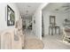 Inviting hallway with neutral decor, tiled floor, decorative accents, and an open concept design at 9734 Branching Ship Trce, Wesley Chapel, FL 33545