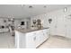 Bright kitchen boasts a large island with granite countertops, seamlessly flowing into the adjacent living area at 9734 Branching Ship Trce, Wesley Chapel, FL 33545