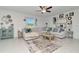 Bright living room featuring a sectional sofa, natural light, and a decorative area rug at 9734 Branching Ship Trce, Wesley Chapel, FL 33545