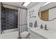 Modern bathroom featuring black hexagon tile in the shower, white vanity, and stylish mirror at 9821 113Th St # 201, Seminole, FL 33772
