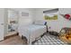 Bedroom featuring a twin sized bed, neutral decor, blue accents, and a window providing natural light at 9821 113Th St # 201, Seminole, FL 33772