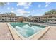 Outdoor pool area surrounded by brick pavers and buildings at 9821 113Th St # 201, Seminole, FL 33772