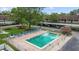 Aerial view of a community pool, lounge chairs, and covered parking at 9821 113Th St # 201, Seminole, FL 33772