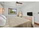 Bedroom featuring a queen sized bed, neutral decor, ceiling fan, and a window with natural light at 9821 113Th St # 201, Seminole, FL 33772