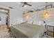 Bedroom with a decorative headboard, modern lighting, queen sized bed, and a closet to the left at 9821 113Th St # 201, Seminole, FL 33772