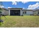 A spacious backyard and screened lanai provide a great space for outdoor living and entertaining at 10098 Banyan Breeze Blvd, Land O Lakes, FL 34638