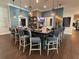 This is a view of the bar area with bar seating, pendant lighting, and a television at 10098 Banyan Breeze Blvd, Land O Lakes, FL 34638