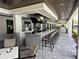 Outdoor bar area featuring barstools, televisions, patterned tiles, and an open layout at 10098 Banyan Breeze Blvd, Land O Lakes, FL 34638