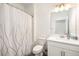 Clean bathroom featuring a toilet, vanity with sink, shower with a curtain, and modern fixtures at 10098 Banyan Breeze Blvd, Land O Lakes, FL 34638