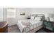 Cozy bedroom with carpet, a decorative bed frame, and matching nightstands with lamps at 10098 Banyan Breeze Blvd, Land O Lakes, FL 34638