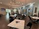 This is a view of the dining room with tables, chairs, pendant lighting, and artwork at 10098 Banyan Breeze Blvd, Land O Lakes, FL 34638