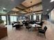 A gathering room with tables, chairs, and chandeliers for community members to enjoy at 10098 Banyan Breeze Blvd, Land O Lakes, FL 34638