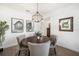 Stylish dining room offers a modern chandelier and ample natural light at 10098 Banyan Breeze Blvd, Land O Lakes, FL 34638