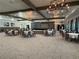 The event space features tables, chairs, chandeliers, and a stage area at 10098 Banyan Breeze Blvd, Land O Lakes, FL 34638