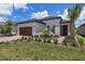 Charming single-story home with a two-car garage, well-manicured lawn, and inviting front door at 10098 Banyan Breeze Blvd, Land O Lakes, FL 34638