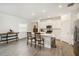 Bright kitchen features an island with seating and stainless steel appliances at 10098 Banyan Breeze Blvd, Land O Lakes, FL 34638