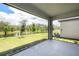 Screened lanai view of a tranquil pond and landscape, offering privacy and beauty at 10098 Banyan Breeze Blvd, Land O Lakes, FL 34638