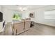 Spacious living room with neutral decor, wood-look tile flooring, and sliding glass doors leading to the backyard at 10098 Banyan Breeze Blvd, Land O Lakes, FL 34638