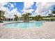Resort-style pool with palm trees, lounge chairs, cabanas, and clear blue water under a sunny sky at 10098 Banyan Breeze Blvd, Land O Lakes, FL 34638