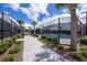 Tennis courts surrounded by lush landscaping, palm trees, and a walking path at 10098 Banyan Breeze Blvd, Land O Lakes, FL 34638